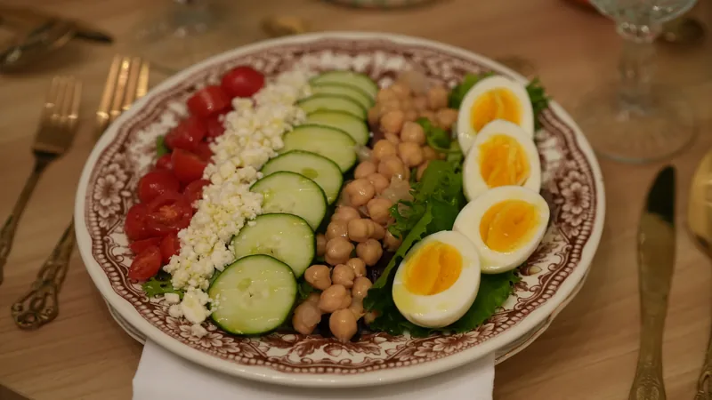 Fresh Mediterranean salad with greens, cucumber and tomatoes.